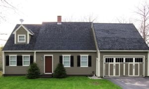 Paint colors, shutters, carriage house garage door and removal of storm door greatly improve curb appeal.