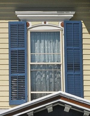 rectangular shutters on arched window
