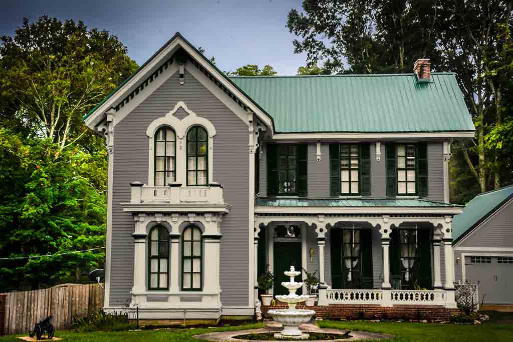 gray italianate with green metal roof