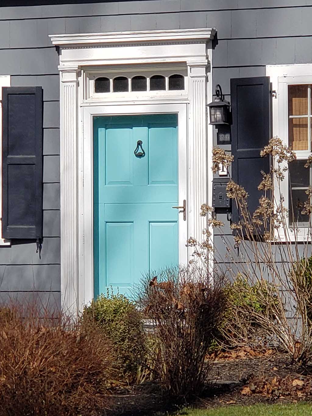 turquoise front door with storm door